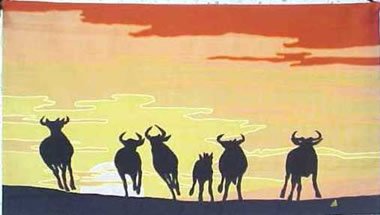 wildebeest running sunrise